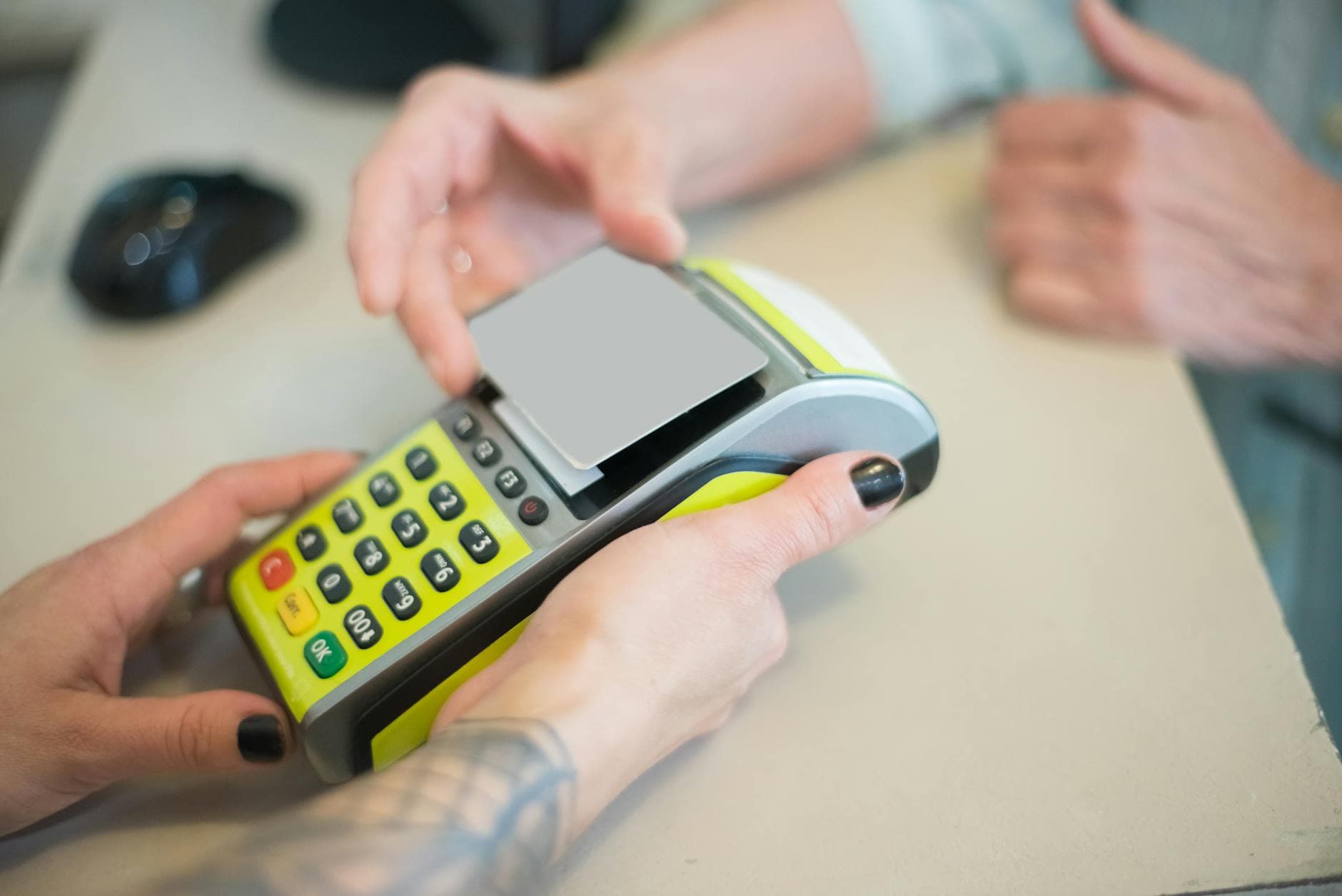 Hands engaging in a secure card transaction with a payment terminal, capturing the essence of modern