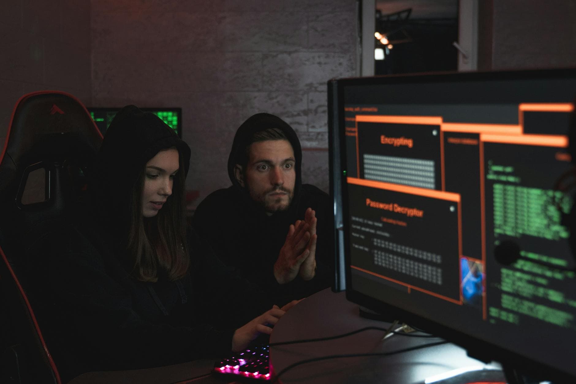 Fraud analyst reviewing a multi-monitor dashboard for contact centre payment fraud signals