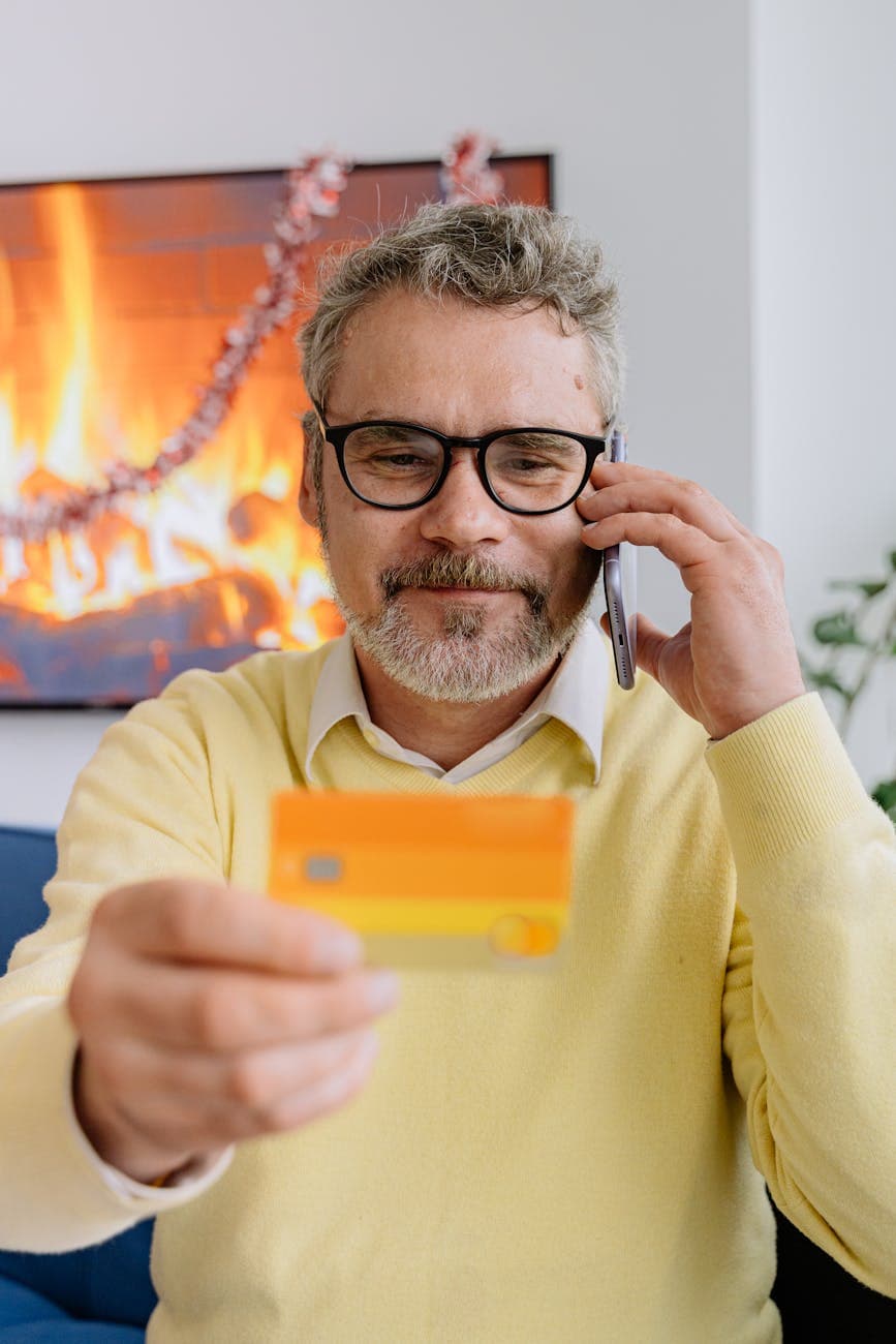 Person on the phone making a card payment with a notepad of details