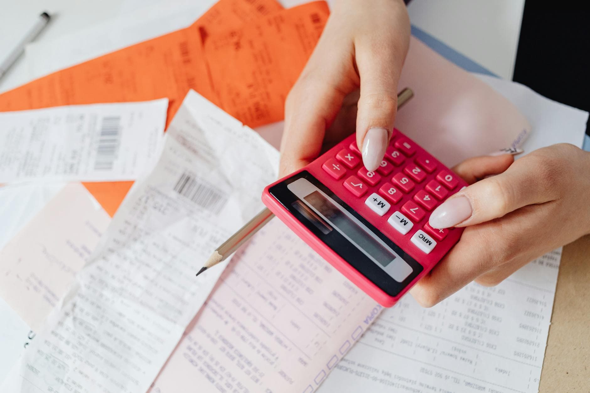 Calculator and financial documents showing PCI compliance cost breakdown