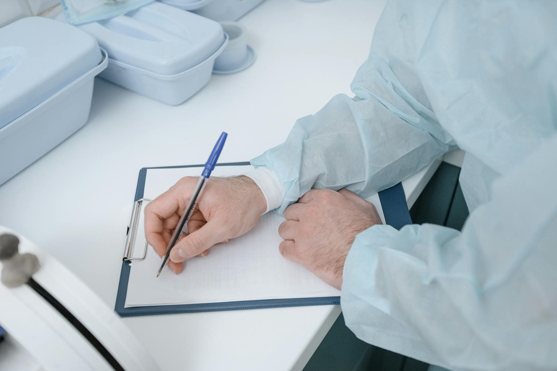 A clinician reviewing medical documents, representing the PHI a HIPAA business associate handles under a signed BAA.