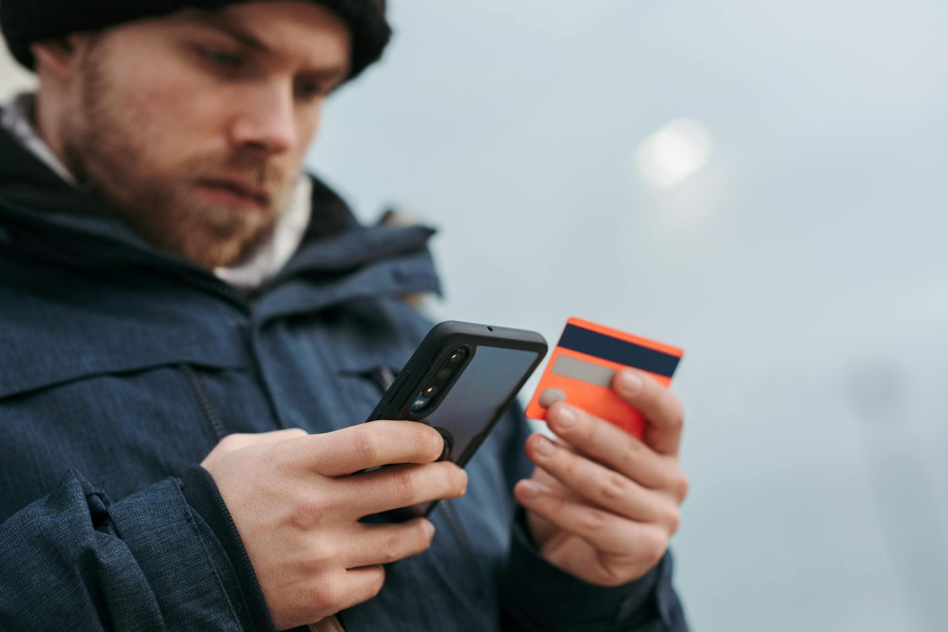Customer entering card details on a mobile phone during a payment