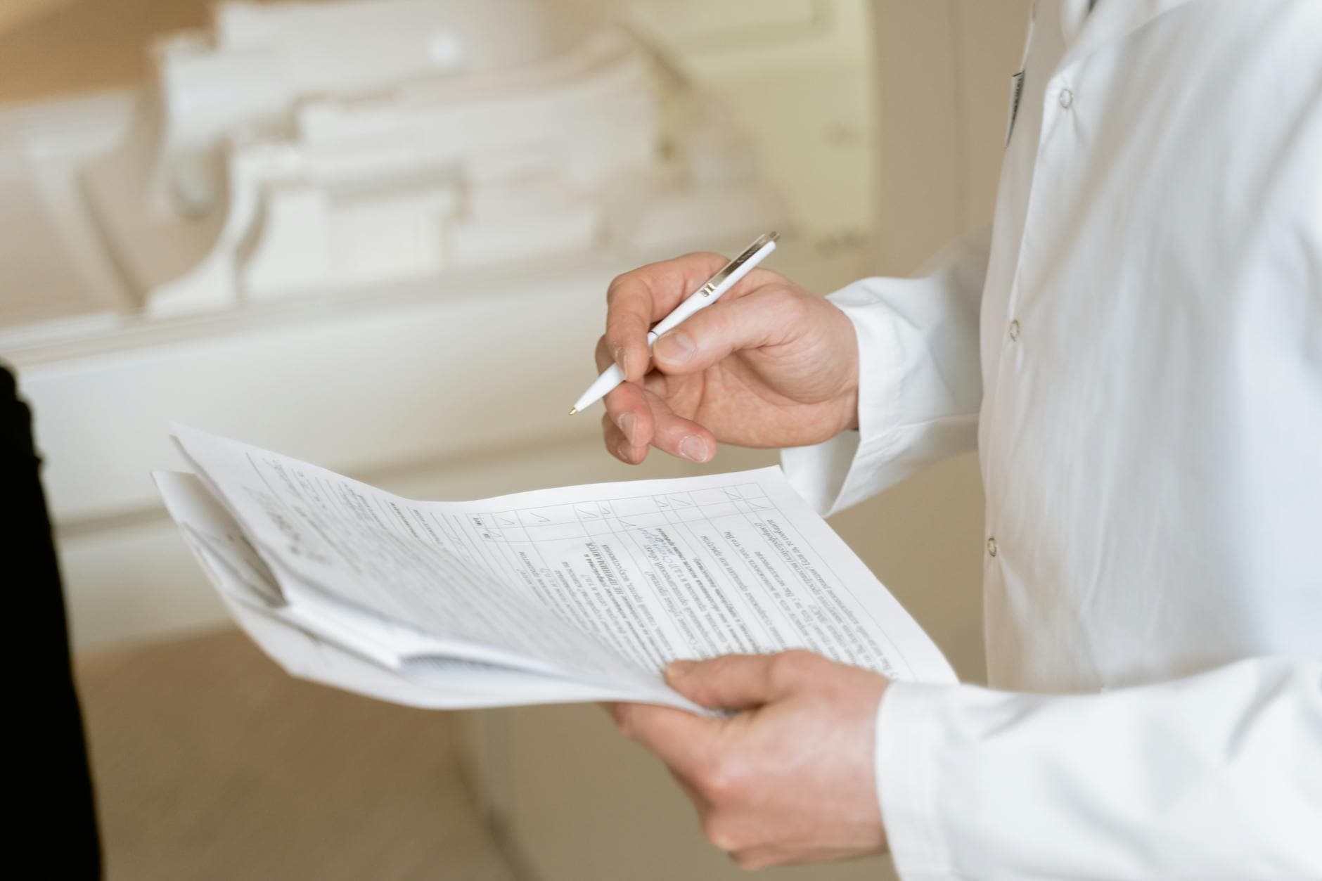 A clinician reviewing medical documents, representing the PHI a HIPAA business associate handles under a signed BAA.
