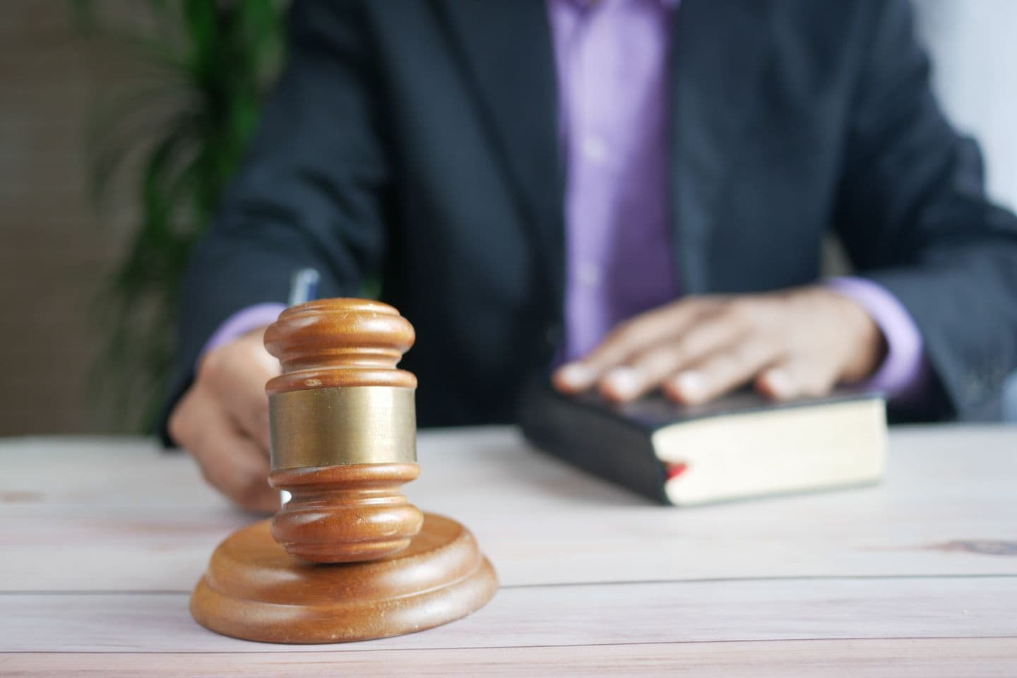 A gavel resting on a legal book — three US states have written payment card security requirements into statute