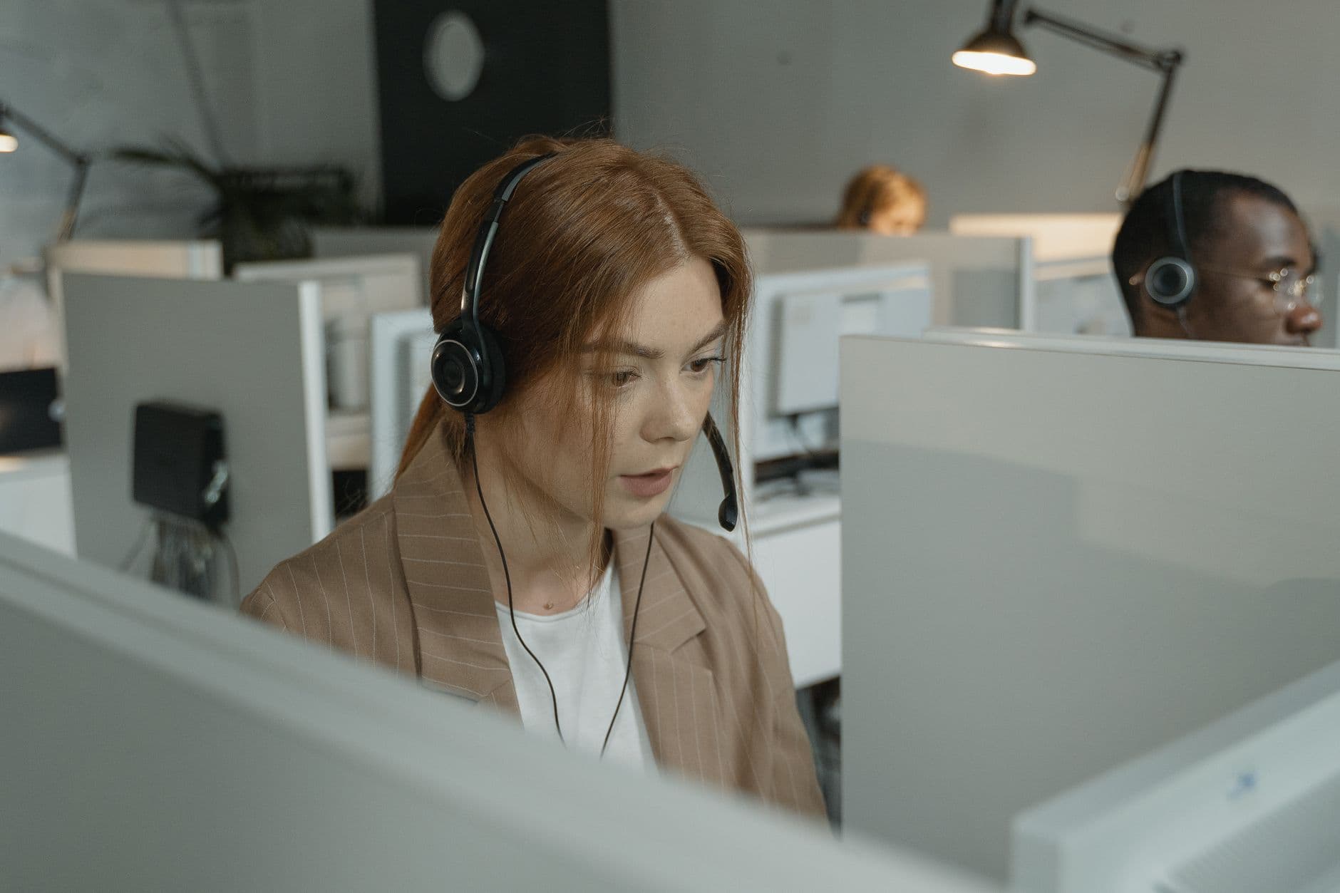 Utility contact centre agents wearing headsets handling bill payment calls