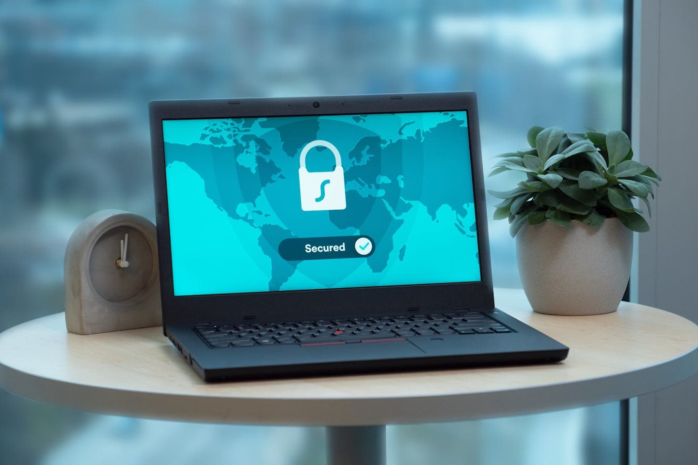 Laptop displaying a security lock icon next to a clock — representing PCI DSS v4.0.1 controls and audit deadlines