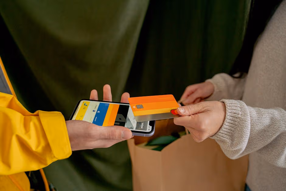 A close-up of a contactless payment using a credit card and smartphone, highlighting modern technology.