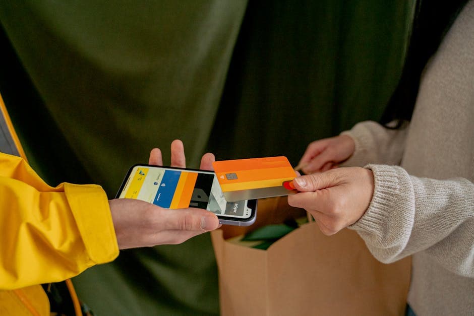 A close-up of a contactless payment using a credit card and smartphone, highlighting modern technology.