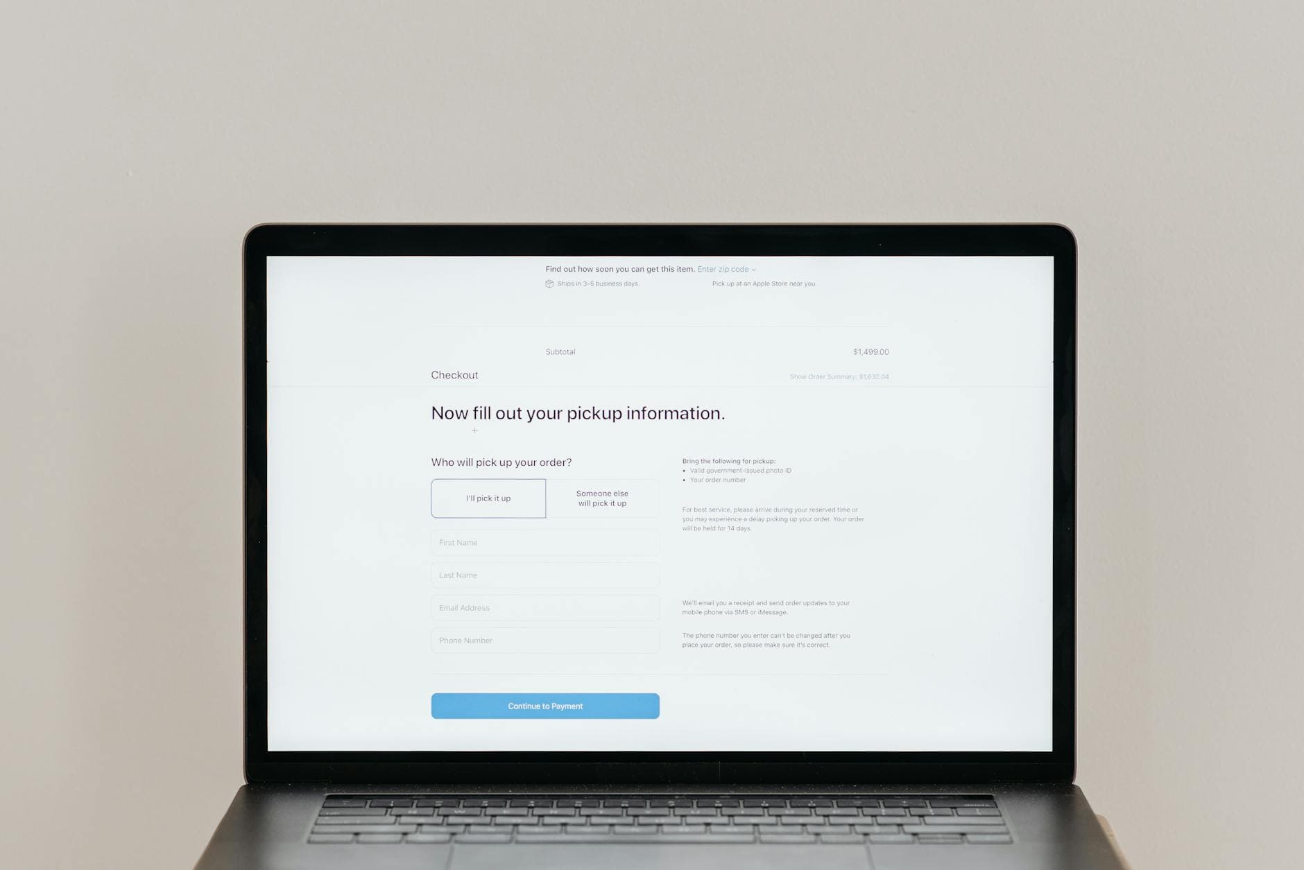 Laptop displaying an online checkout form on a clean desk