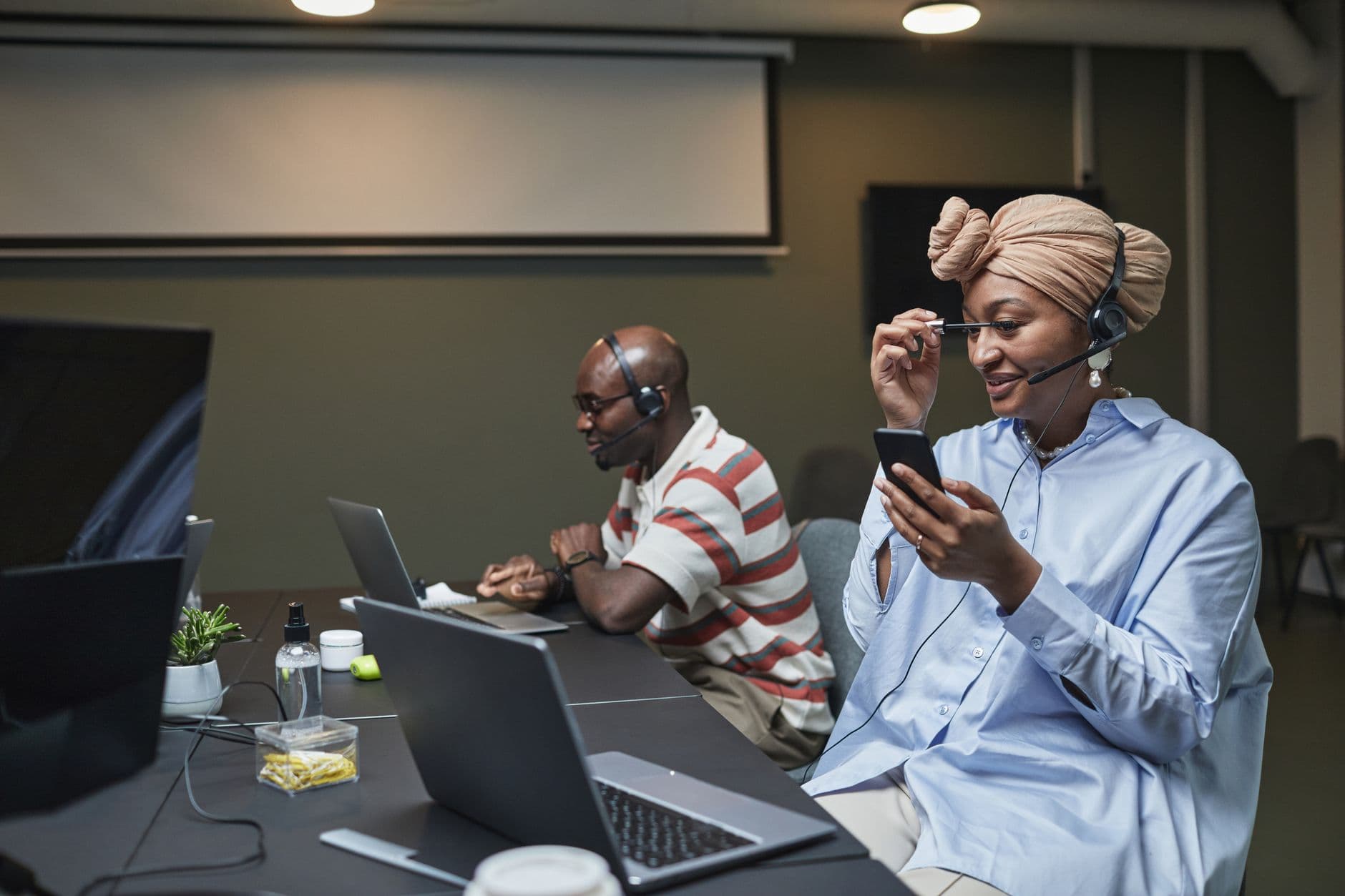 Enterprise contact centre team working at desks with headsets in a modern office