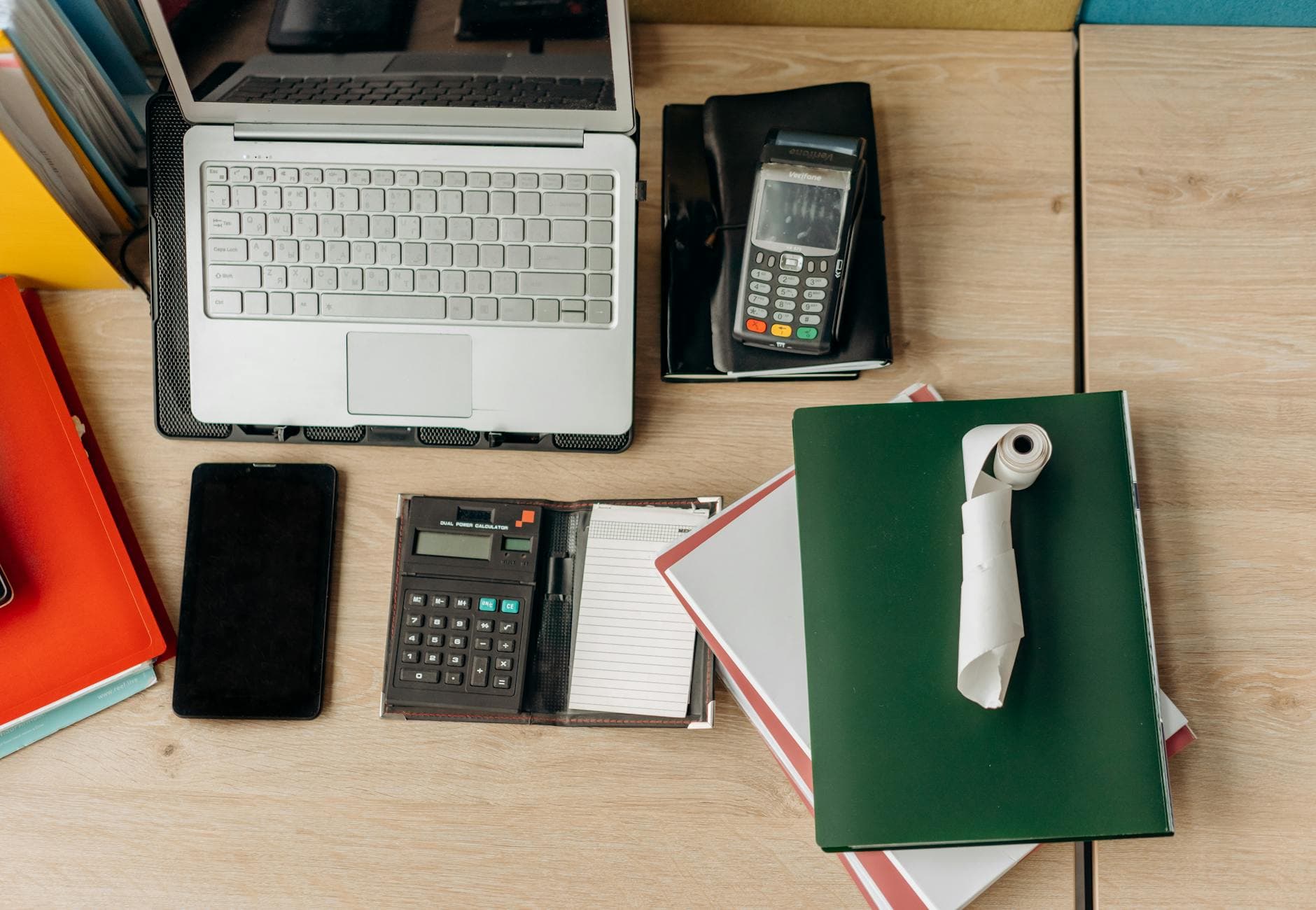 Office desk with laptop, calculator and payment terminal — PCI DSS v4.0.1 audit prep