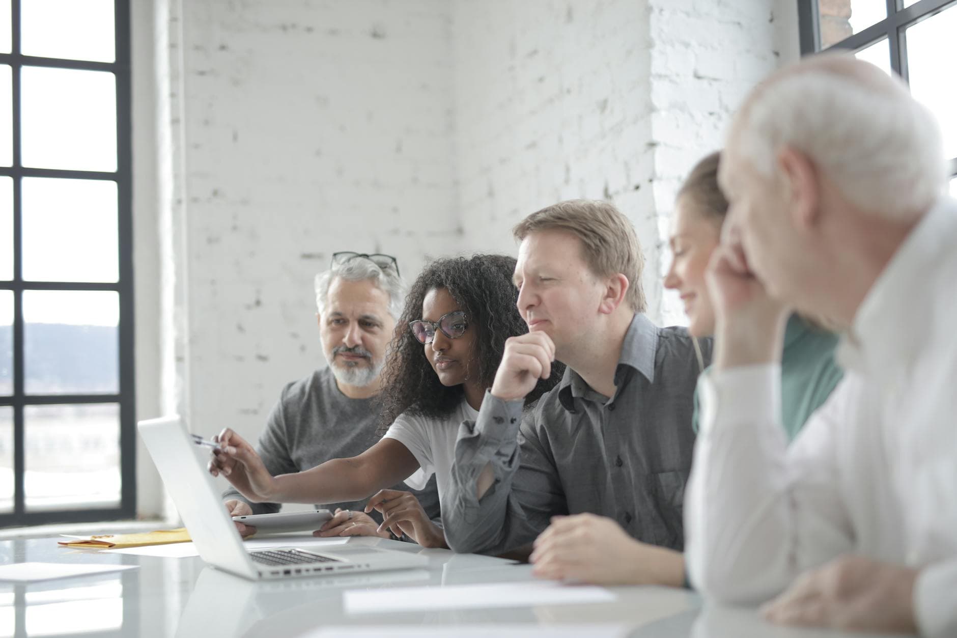 Team reviewing a project on a laptop in an office