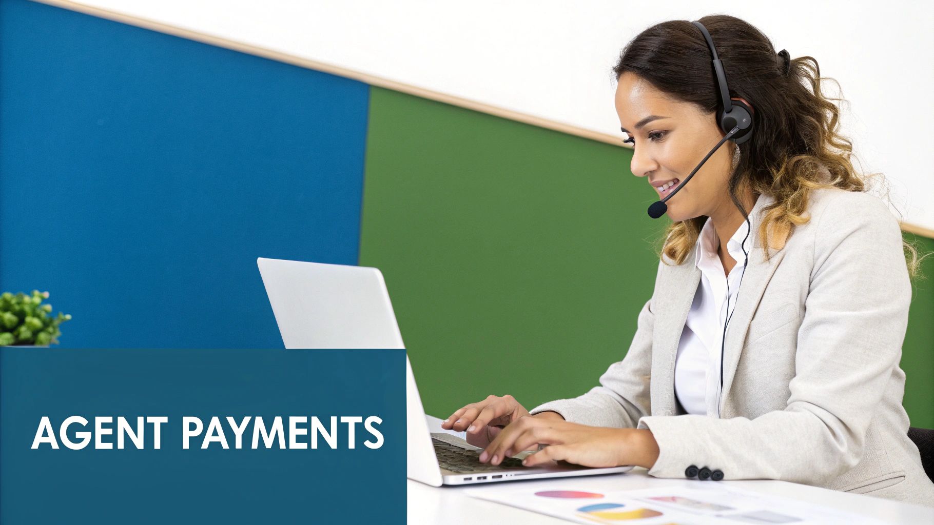 A smiling customer service agent with a headset typing on a laptop in an office.