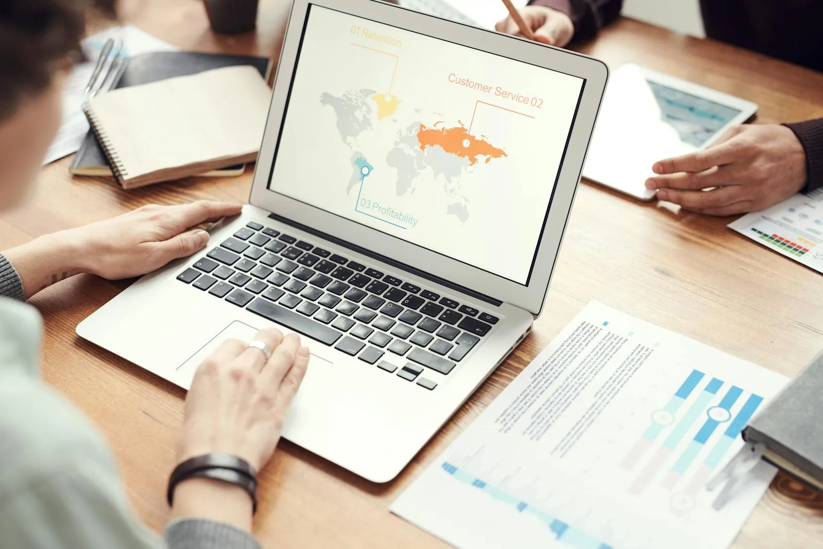 Analyst tracing a data flow diagram on a laptop screen showing how information moves between systems