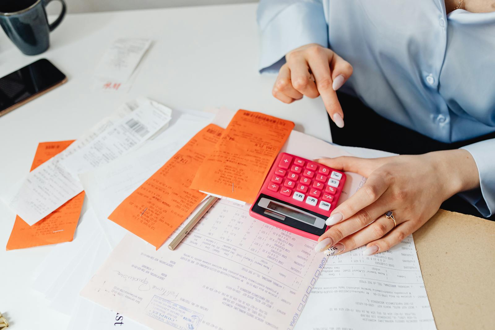 Calculator and printed receipts on a desk representing counting annual card transaction volumes