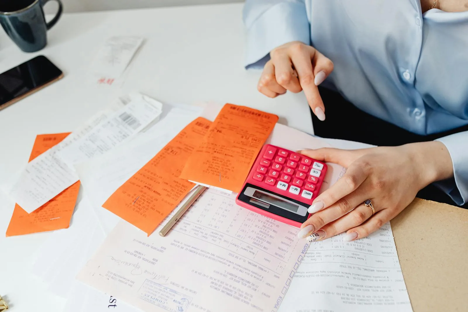 Calculator and printed receipts on a desk representing counting annual card transaction volumes