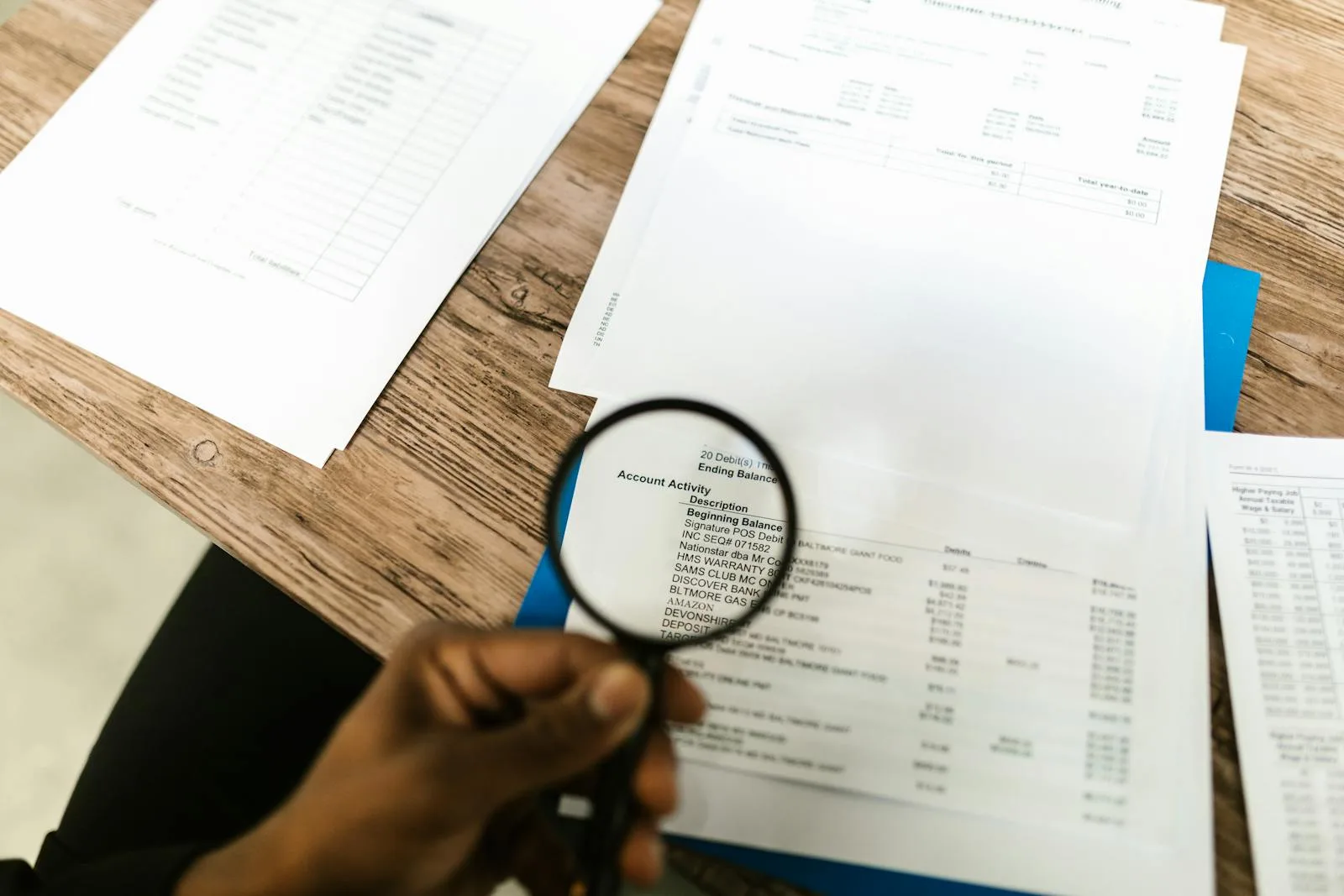 Auditor reviewing compliance documents with a magnifying glass for a service provider assessment