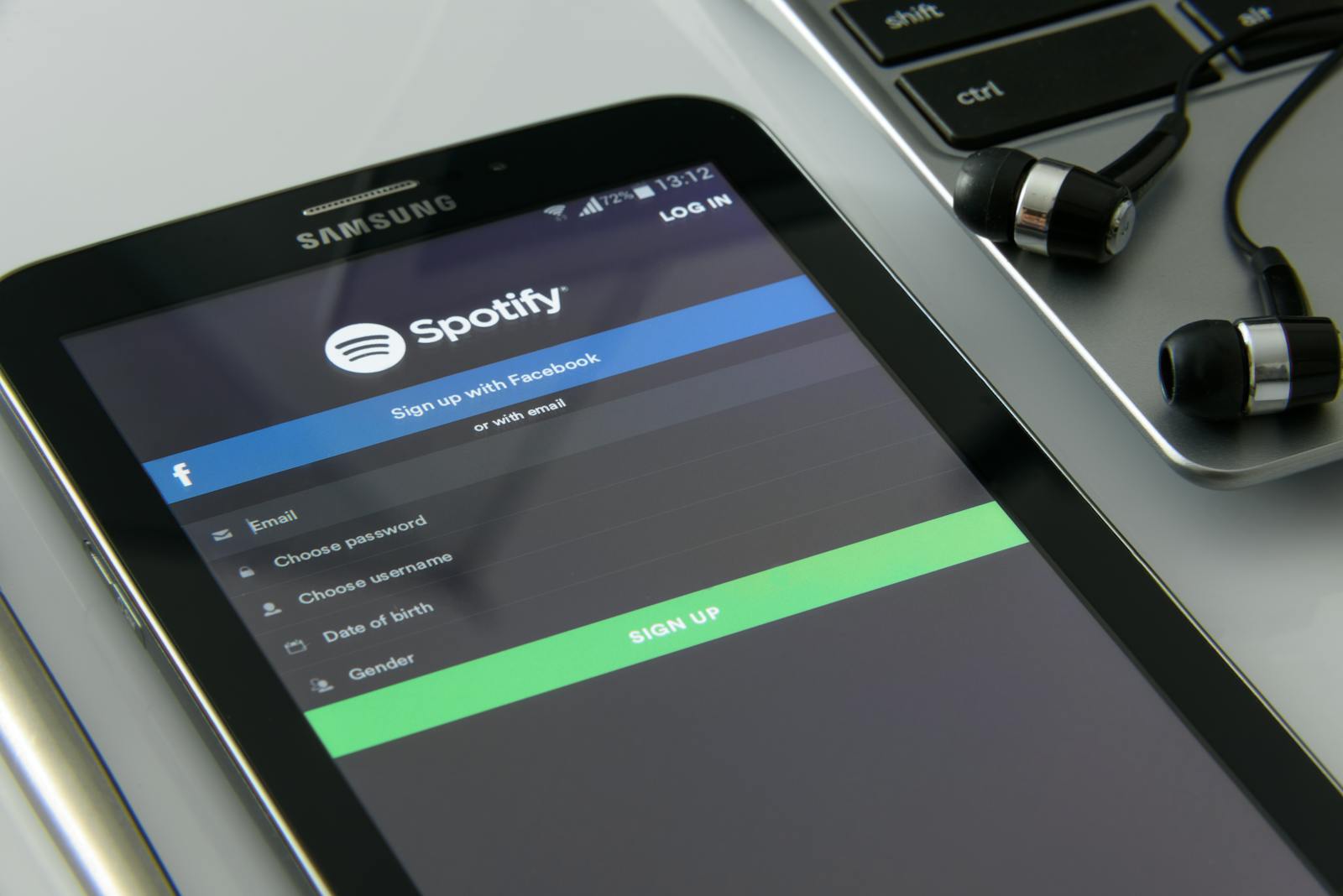 Person entering a multi-factor authentication code on a smartphone while logging in on a laptop