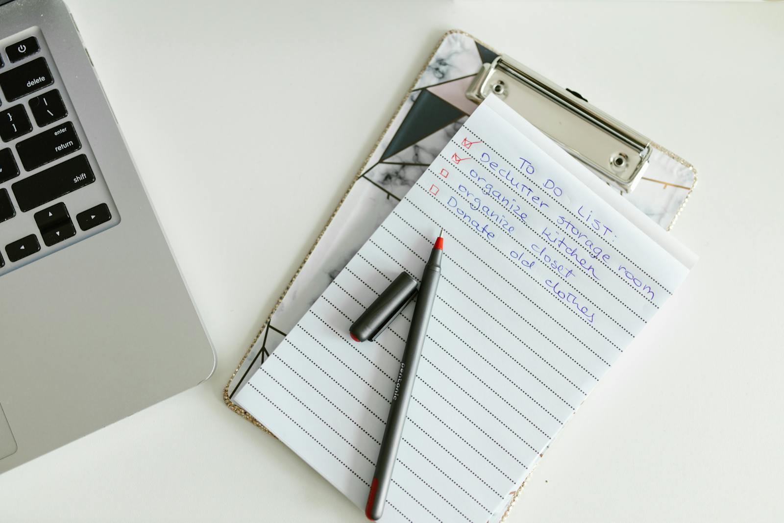 A compliance checklist on a clipboard with a pen, representing a PCI DSS Self-Assessment Questionnaire being filled in