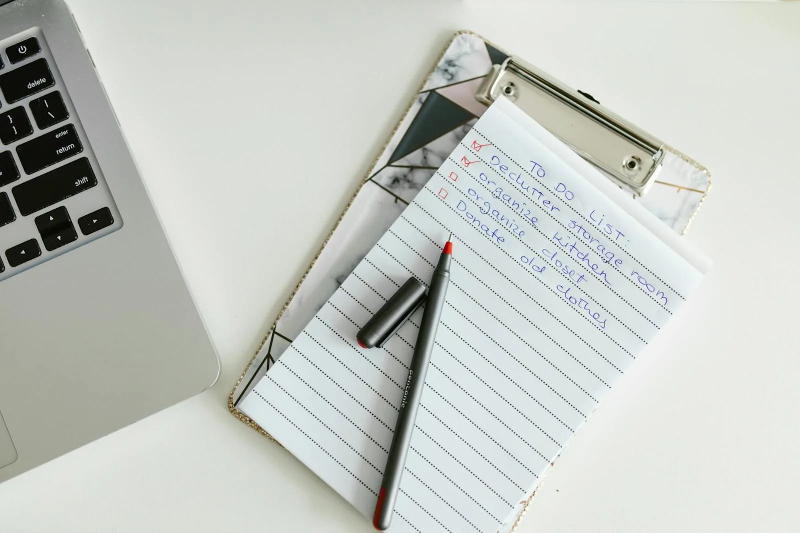 A compliance checklist on a clipboard with a pen, representing a PCI DSS Self-Assessment Questionnaire being filled in