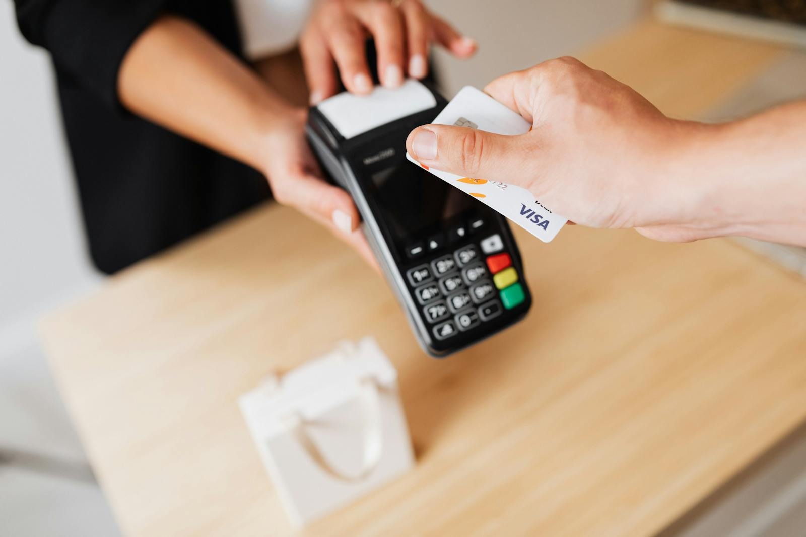 A card payment terminal on a retail counter, illustrating different payment acceptance methods that map to SAQ types